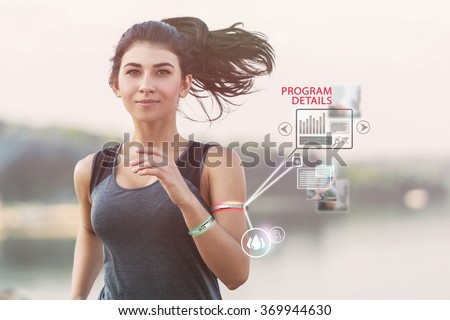 Young girl running on a beach during morning with wearable devices
