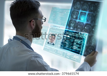 Doctor holding brain mri and examining it using virtual future technology