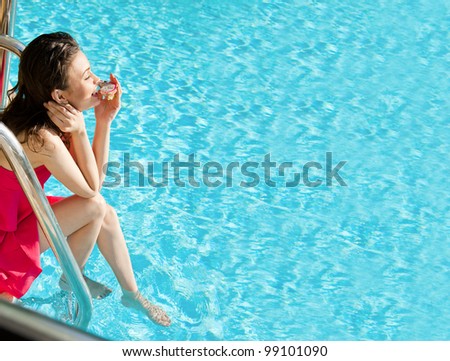 Beautiful natural woman smiling and eating dragon fruit at pool on summer vacations