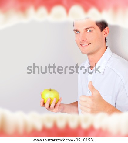 Mouth with teeth from inside and dentist holding green apple and thumbs up