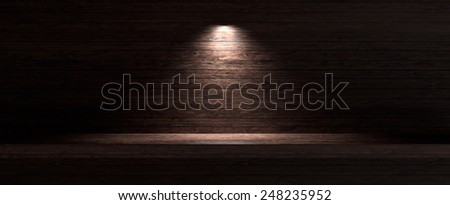 Dark wooden background with spotlight lamp