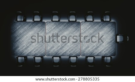 Top view at a meeting table and leather covered chairs on a vast, empty, abstract reflective space with a light focused on a table surface.