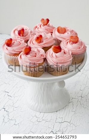 Strawberry cupcakes with pink filling and strawberry hearts