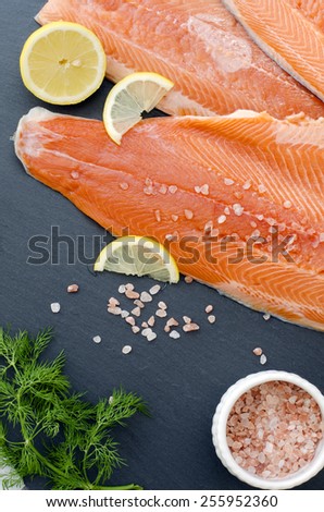 fresh salmon fillet with aromatic herbs, spices and vegetables - healthy food, diet or cooking concept