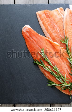 Fresh salmon fillet with aromatic herbs. Healthy food, diet or cooking concept.