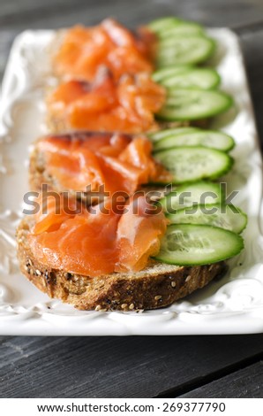 Salmon Canapes. Small sandwiches with salmon and cucumber.