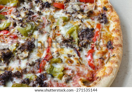 Pizza background. Pizza with meat, bell pepper, onions, cheese and herbs as food background or texture.