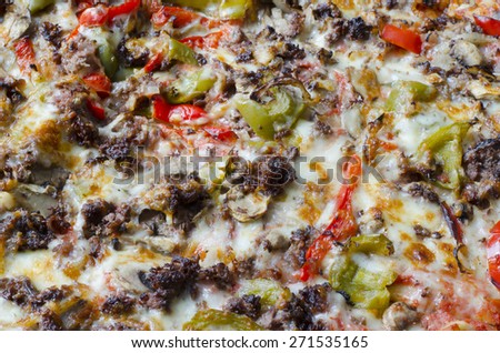 Pizza background. Pizza with meat, bell pepper, onions, cheese and herbs as food background or texture.