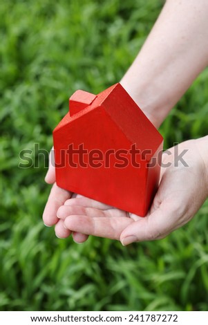 Red house in hands