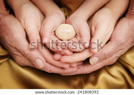 Loving Family - love on stone in family hands