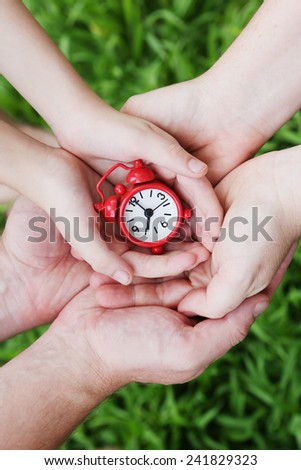 Family Time - alarm clock in family hands