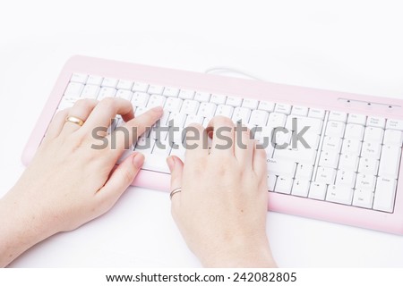 Typing on a pink keyboard