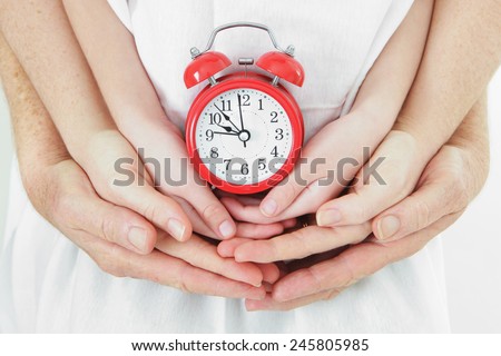 Family time - Father, Mother, and Child holding an alarm clock