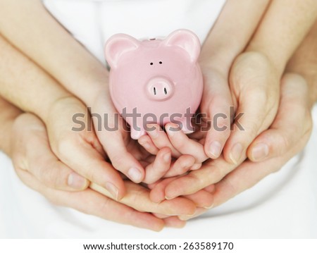 Piggy Bank in hands of a family