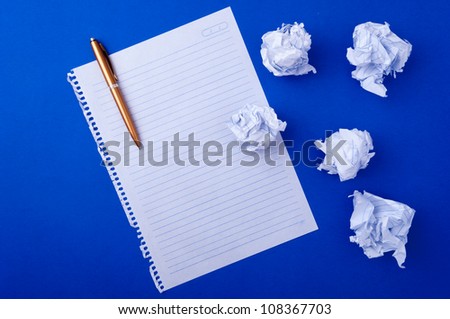 copybook paper, pen and crushed leaves