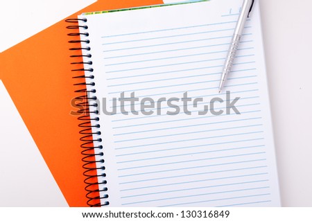 Blank spiral notebook with pen for notes
