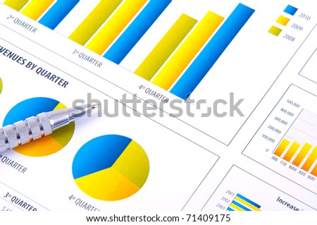 Analysis with charts of progress in business and metallic pen