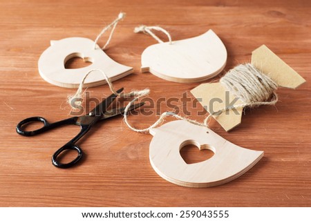 hands of wood crafts, scissors, rope