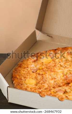 Tasty pizza in box