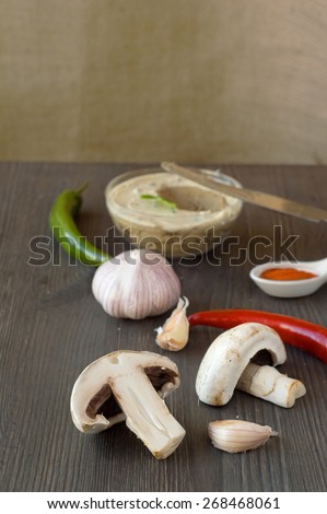 Fresh chicken pate with vegetables and herbs on a wooden chopping board