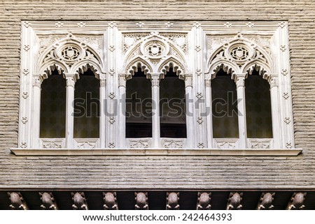 Three gothic windows in a facade of a building. Horizontal composition