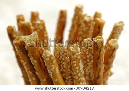 Closeup of salty sticks with sesame in a glass