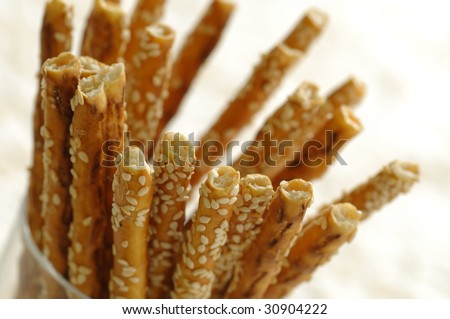 Closeup of salty sticks with sesame in a glass