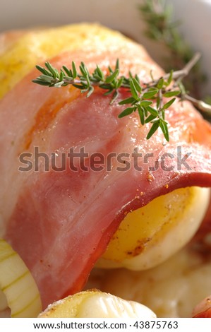 Freshly baked dish of potatoes rolled with bacon