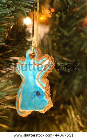 Bitten Gingerbread Cookie Hanging on a Christmas Tree