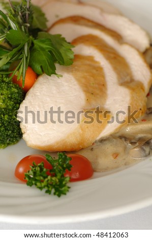 Chicken filled served with chanterelle sauce, rice and vegetables garnish in restaurant