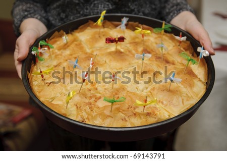 Banitsa is a traditional Bulgarian pastry - mixture of whisked eggs and pieces of sirene between filo pastry. Traditionally, lucky charms are put into the pastry on certain occasions.