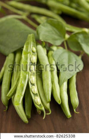 Fresh raw runner beans on wooden background