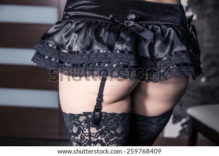 body of a woman in stockings with suspenders
