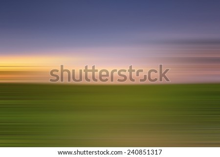 Long Exposure Of Blue Sky At The Green Field During Sunset With Sky Motion For Background