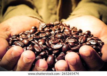 Coffee Farmer Showing Coffee Beans - Warm Light
