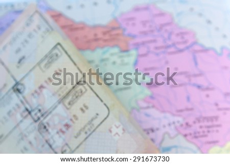 Abstract - blurred opened passport on map background - travel concept
