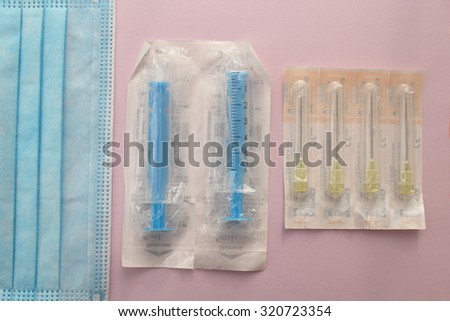 Surgical mask, syringe and needle - sterile medicine equipment