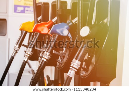 Close up of petroleum gasoline station service - oil refueling and refilling for car transportation concept
