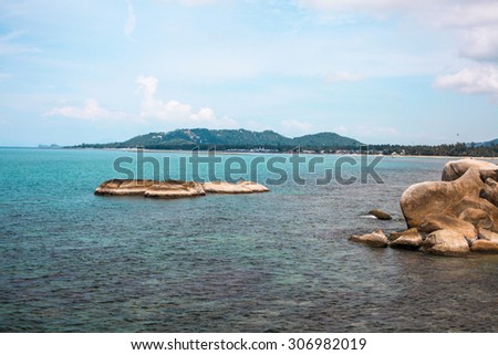 Idyllic blue sea and clear sky and stand-alone small island.Taken in Koh Samui, Thailand