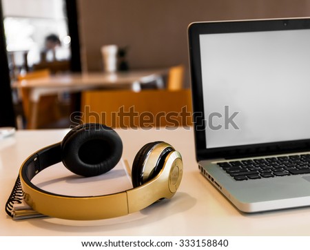 Laptop and Headphone on working desk station. It could be perfect for designers or sound engineer or other related job occupations