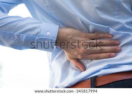 Man in office uniform having back pain issue / back injury