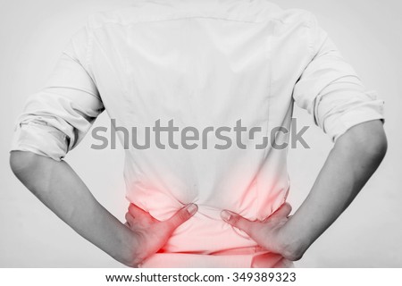 Young man in casual office shirt having hip pain (Selective Focus)