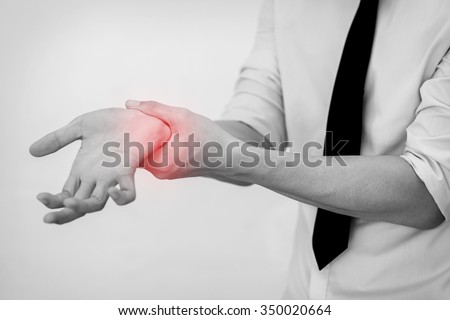 Office Man touching painful wrist. Pain in a man wrist. (Selective Focus)