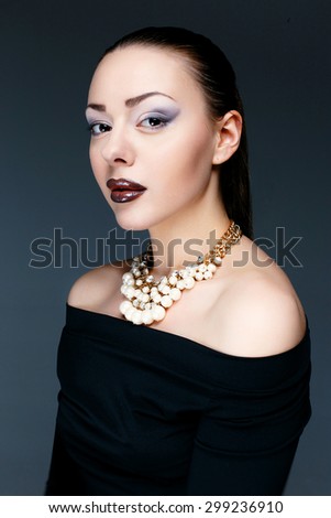 Beautiful female model posing in jewelry necklace