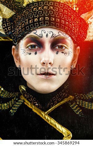 Close up portrait of Beautiful Golden Venetian Carnival Masked woman,sun costume