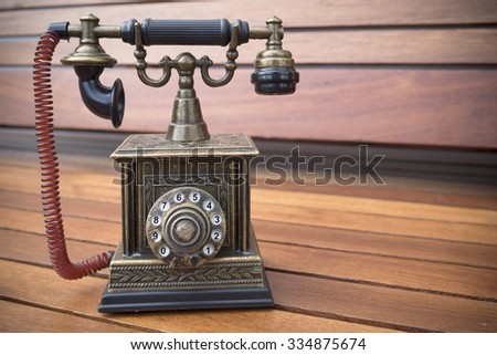 Lighter in retro classic phone model, vintage old dial Telephone on wood background