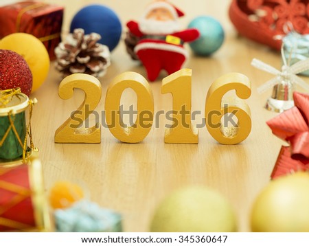 Text of gold 2016, make from wood. Golden year 2016. New year decoration, closeup on 2016 text. Happy new year 2016. Gold 2016 on wood floor with copy space at the bottom for your text.
