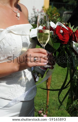 stock photo Bride with wedding bouquet and a glass of champagne