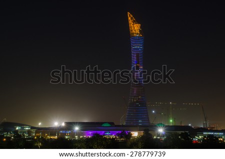 DOHA, QATAR - MAY 17: The Aspire Park and Aspire Tower or Torch Hotel in Doha Sports City at night. May 17, 2015 in Doha, Qatar, Middle East