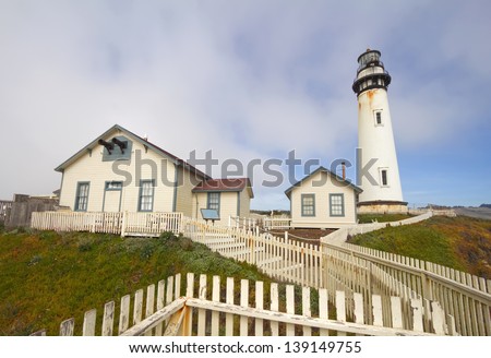 The Pigeon Point Lighthouse and white picket fence located in Pigeon Point Light Station State Historic Park between Half Moon Bay and Santa Cruz on the central California coast